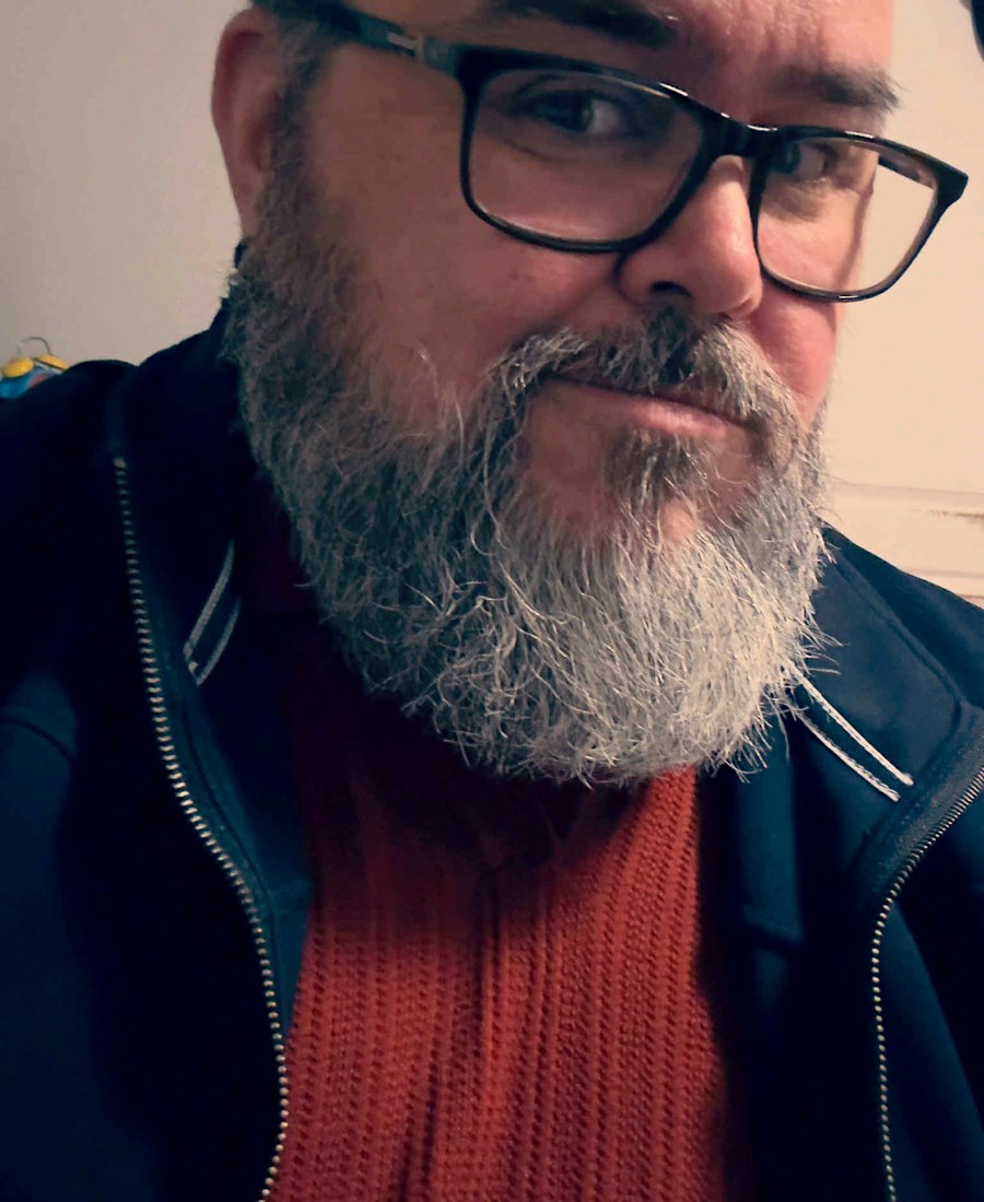 Jason Rosenburg wearing a blue jacket and glasses