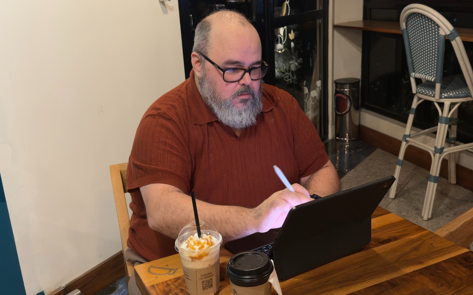 Jason Rosenburg writing in a coffee shop