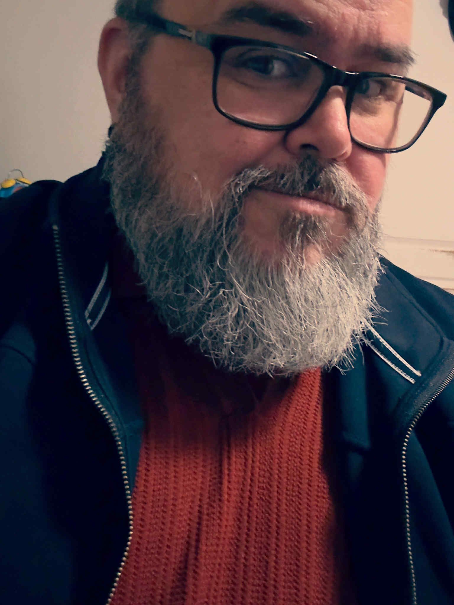 Jason Rosenburg wearing a blue jacket and glasses